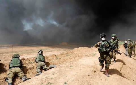 Israeli forces are deployed near the Kibbutz Nir Oz at the Gaza border - Credit: MENAHEM KAHANA/AFP/Getty Images