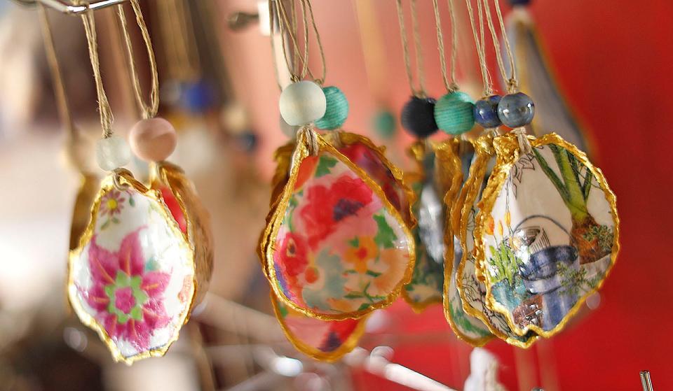 Denise Miller, of Duxbury, creates home décor and ornaments using oyster shells for her business, Beachcomber Creations, on Monday, April 11, 2022 .