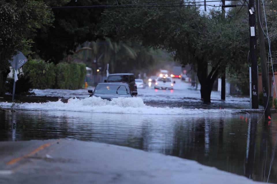 A car pushes its way through deep floodwaters near Northeast 108th Street and Northeast 13th Avenue in North Miami. Courtesy of Cory Boehne