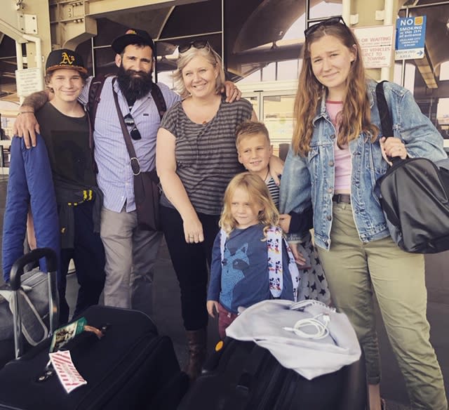 Charles MacDonald, second from left, stands next to his wife, Janelle Hanchette, surrounded by their four children — from left, Rocket, George and Ava, and, in front, Arlo — at the San Francisco International Airport on their way to the Netherlands in July. (Photo: courtesy of the family)