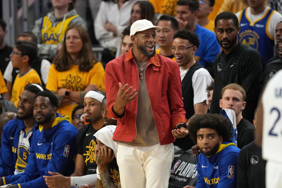 Andre Iguodala, center, stands in front of the Golden state Warriors bench during Game 4 of the 2023 NBA playoff series against the Sacramento Kings on April 23, 2023.