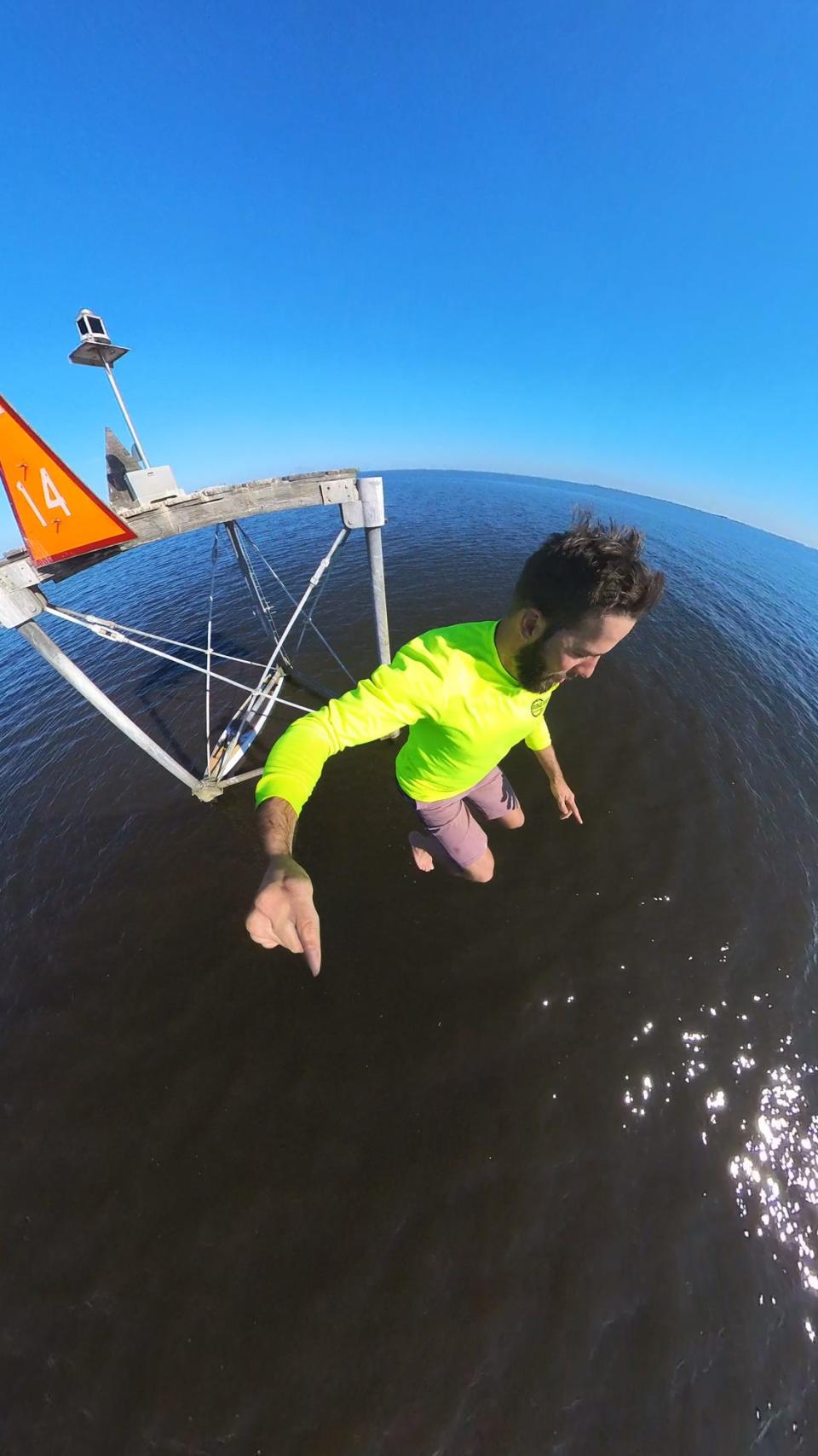 Jordon Wolfram jumps from a channel marker during his journey across Lake Okeechobee on Dec. 31. He and a friend, Mason Gravley, traversed Florida's largest lake on stand-up paddleboards, in part to draw attention to the need for conservation efforts in Florida.