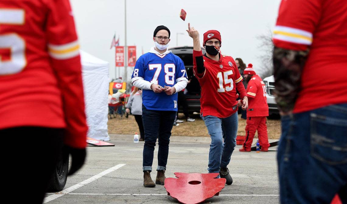 Brothers John, left, and Kyle Davidson play cornhole with family while tailgating before the start of the AFC Championship between the Kansas City Chiefs and the Buffalo Bills on Sunday Jan. 24, 2021. The brothers grew up in Overland Park but John, now a Bills fan, lives in New York City and Kyle recently moved to Arkansas but shows his support for the Chiefs.