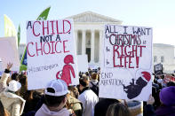 Anti-abortion protesters demonstrate in front of the U.S. Supreme Court, Wednesday, Dec. 1, 2021, in Washington, as the court hears arguments in a case from Mississippi, where a 2018 law would ban abortions after 15 weeks of pregnancy, well before viability.. (AP Photo/Jacquelyn Martin)