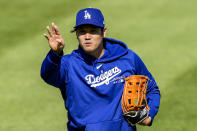 Los Angeles Dodgers' Shohei Ohtani reacts as he throws before a baseball game against the Washington Nationals at Nationals Park, Tuesday, April 23, 2024, in Washington. (AP Photo/Alex Brandon)