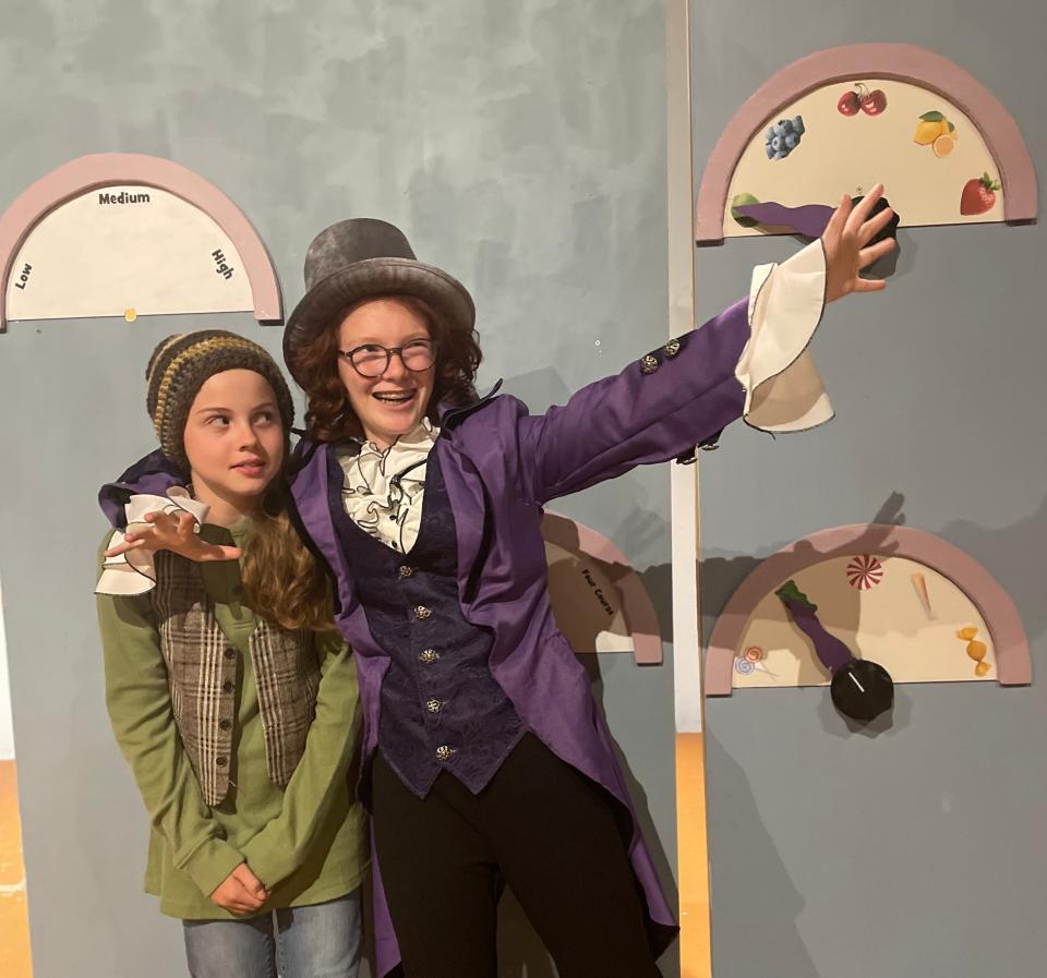 Golden ticketholder Charlie Bucket (Frankie Taylor, left) is given the grand tour by whimsical chocolatier Willy Wonka (Millie Carlson) in Hilliard Arts Council's production of "Charlie and the Chocolate Factory."