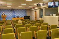 Stephane Dujarric de la Riviere, left, spokesperson for the United Nations Secretary-General António Guterres, takes a question from a reporter, right, via video link as others observe social distancing during the noon briefing, Monday, Sept. 21, 2020 at United Nations headquarters. In 2020, which marks the 75th anniversary of the United Nations, the annual high-level meeting of world leaders around the U.N. General Assembly will be very different from years past because of the coronavirus pandemic. Leaders will not be traveling to the United Nations in New York for their addresses, which will be prerecorded. Most events related to the gathering will be held virtually. (AP Photo/Mary Altaffer)