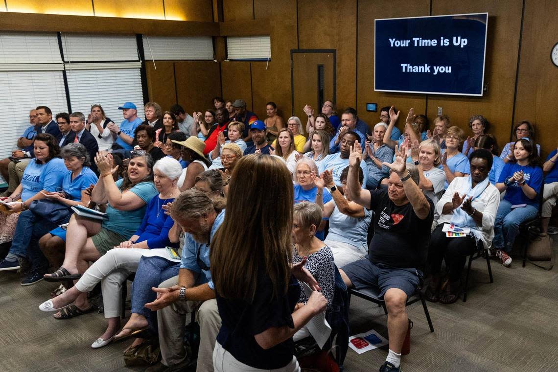 Tess Pratt is applauded by other supporters of Mary Wood, a teacher at Chapin High School, during a board meeting of the Lexington-Rchland 5 school board on Monday, July 17, 2023. Pratt began to tear up describing taking Between the World and Me by Ta-Nehisi Coates away from students.