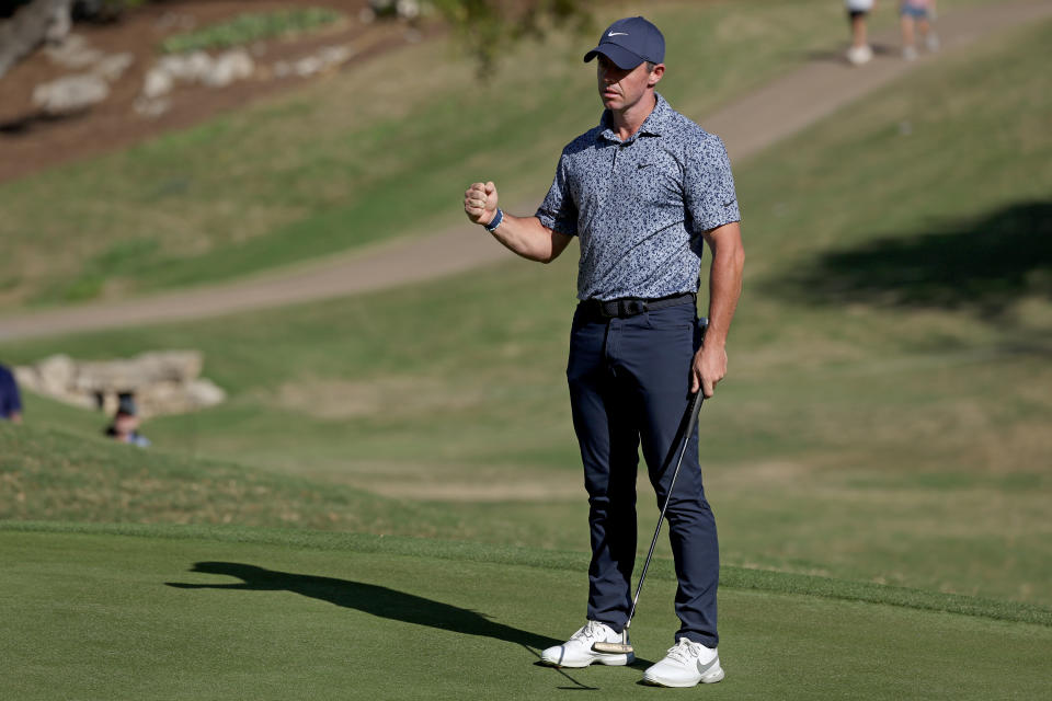 McIlroy fist pumps after holing the winning putt on the 18th hole