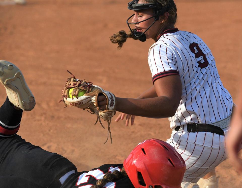 Dewey High School's Londyn Bond, No. 9, just comes up shy of tagging out a Verdigirs High School baserunner  during softball action on Sept. 5, 2023, in Dewey.