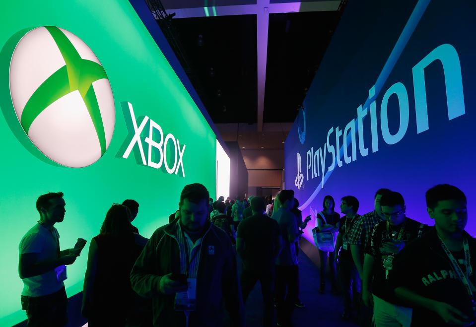 LOS ANGELES, CA - JUNE 16:  Game enthusiasts and industry personnel walk between the Microsoft XBox and the Sony PlayStation exhibits at the Annual Gaming Industry Conference E3 at  the Los Angeles Convention Center on June 16, 2015 in Los Angeles, California. The Los Angeles Convention Center will be hosting the annual Electronic Entertainment Expo (E3) which focuses on gaming systems and interactive entertainment, featuring introductions to new products and technologies.  (Photo by Christian Petersen/Getty Images)