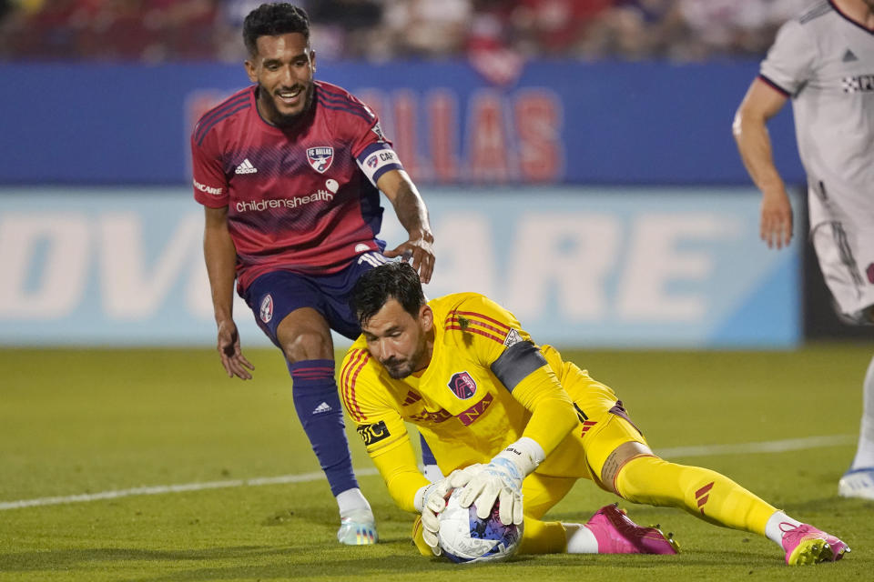 Sporting Kansas City goalkeeper John Pulskamp (1) grabs the ball as FC Dallas forward Jesús Ferreira (10) closes in during the first half of an MLS soccer match Saturday, May 6, 2023, in Frisco, Texas. (AP Photo/LM Otero)