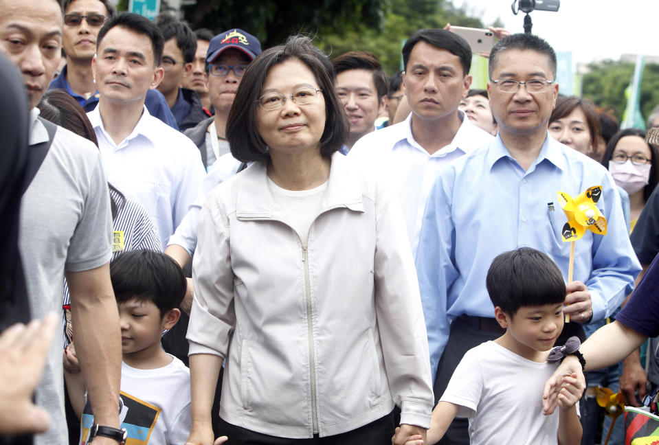 Taiwan's President Tsai Ing-wen, center, holding hands of children marches during an anti-nuclear demonstration in Taipei, Taiwan, Saturday, April 27, 2019. Tsai marched in the streets of Taipei along with hundreds of anti-nuclear protesters to show her determination to build a nuclear-free homeland. (AP Photo/Chiang Ying-ying)