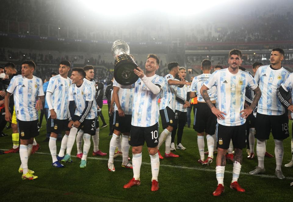 Argentina's Lionel Messi, center, holds the Copa America trophy at the end a qualifying soccer match for the FIFA World Cup Qatar 2022, against Bolivia in Buenos Aires, Argentina, Thursday, Sept. 9, 2021. (AP Photo/Natacha Pisarenko, Pool)