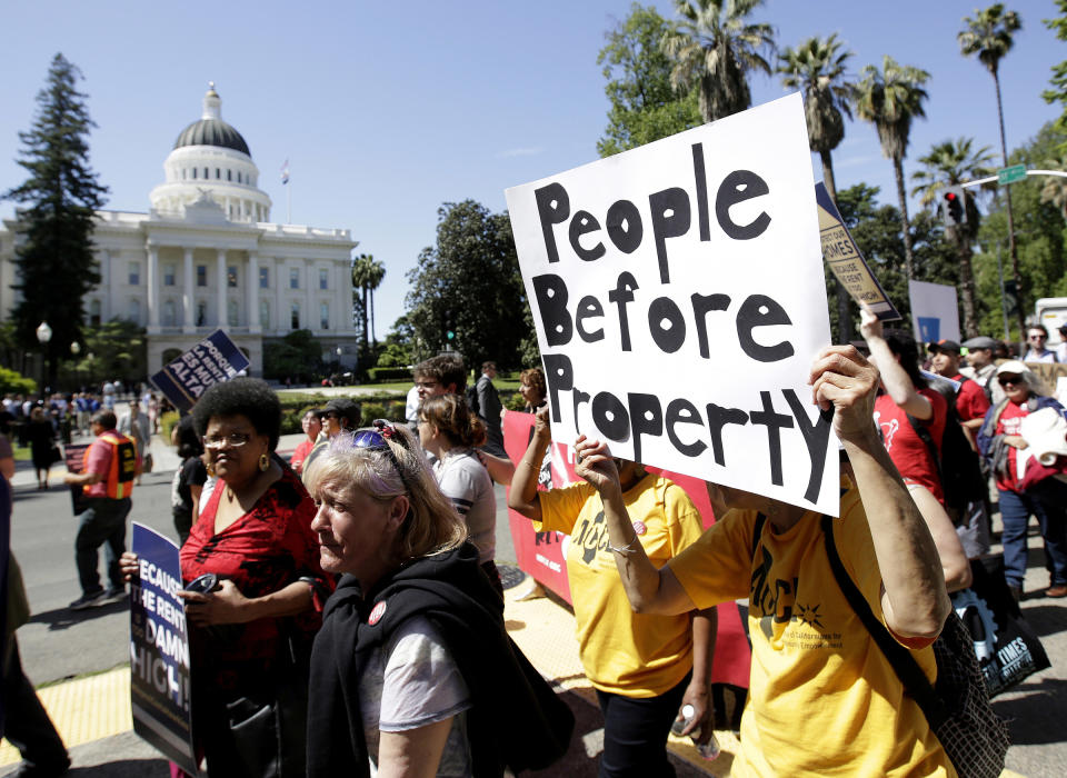 FILE - In this April 23, 2018, file photo rent control supporters march past the Capitol in Sacramento, Calif. Legislators have said repeatedly the state is in the midst of a housing crisis. But the biggest housing bill of the session, which would have overridden local zoning rules in some areas to allow for the construction of more homes, appears to be dead for the year but could be considered next year. (AP Photo/Rich Pedroncelli, File)