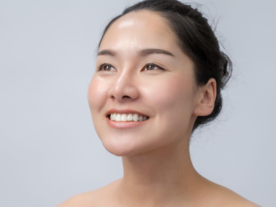 An asian woman with dewy skin