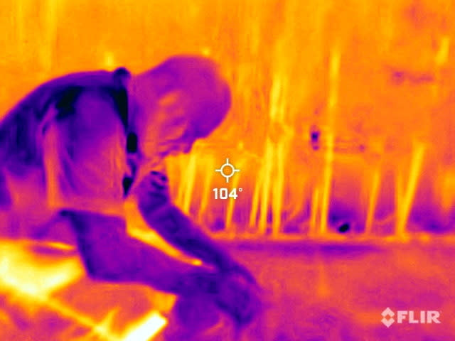 A landscape worker in Phoenix takes a break during a 27-daylong heat wave with temperatures over 110 degrees Fahrenheit