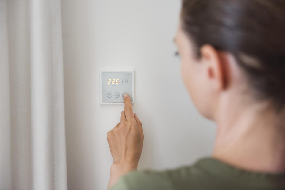 Woman turning on her heating, experts have revealed October 14 is the recommended date.  (Getty Images)