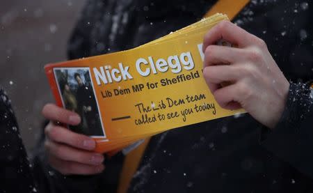 A Liberal Democrat party worker carries leaflets in support of Britain's Deputy Prime Minister Nick Clegg during canvassing in the Hallam constituency of Sheffield, northern England January 28, 2015. REUTERS/Phil Noble
