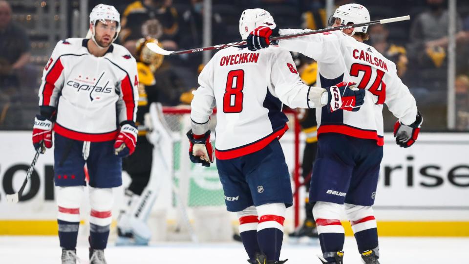 Alex Ovechkin celebrates with teammates Tom Wilson and John Carlson after scoring. (Photo by Adam Glanzman/Getty Images)