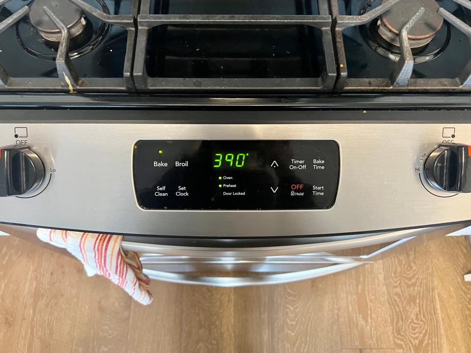 A close-up of an oven with the temperature reading 390 degrees Fahrenheit.