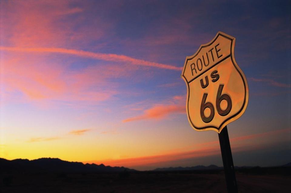 route 66 road sign and sunset