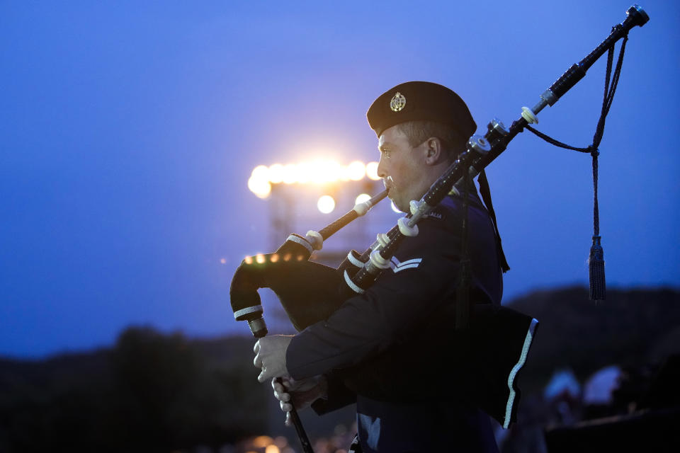 An Australian soldier plays a pipe during the Dawn Service ceremony at the Anzac Cove beach, the site of the April 25, 1915, World War I landing of the ANZACs (Australian and New Zealand Army Corps) on the Gallipoli peninsula, Turkey, early Tuesday, April 25, 2023. During the 108th Anniversary of Anzac Day, travelers from Australia and New Zealand joined Turkish and other nations' dignitaries at the former World War I battlefields for a dawn service Tuesday to remember troops that fought during the Gallipoli campaign between British-led forces against the Ottoman Empire army. (AP Photo/Emrah Gurel)