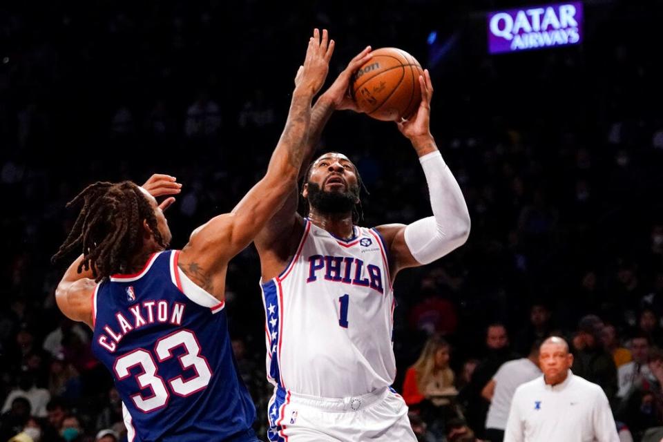 The Sixers' Andre Drummond tries to shoot over the Nets' Nic Claxton during Thursday's game.