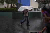 A man uses a plastic bag as cover from the rain in Caracas, Venezuela, Wednesday, June 29, 2022. Forecasters issued a hurricane watch for the Nicaragua-Costa Rica border as a tropical disturbance sped over the southern Caribbean on a path toward Central America. Venezuela shuttered schools, opened shelters and restricted air and water transportation on Wednesday as President Nicolas Maduro noted that the South American country already has been struggling with recent heavy rains. (AP Photo/Ariana Cubillos)