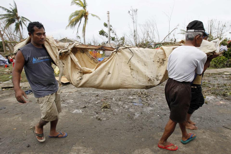 Residents carry the body of a loved one after super Typhoon Haiyan battered Tacloban city