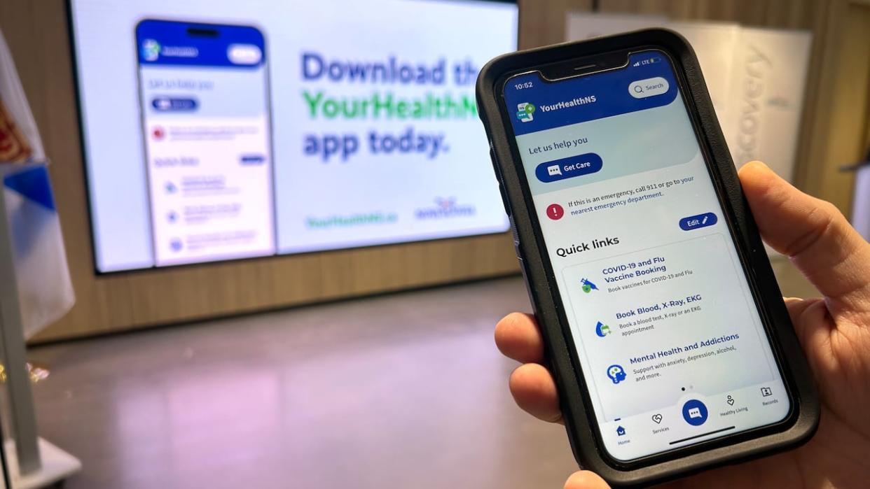 The YourHealthNS app is displayed last November at a news conference announcing its launch. (Jonathan Villeneuve/Radio-Canada - image credit)