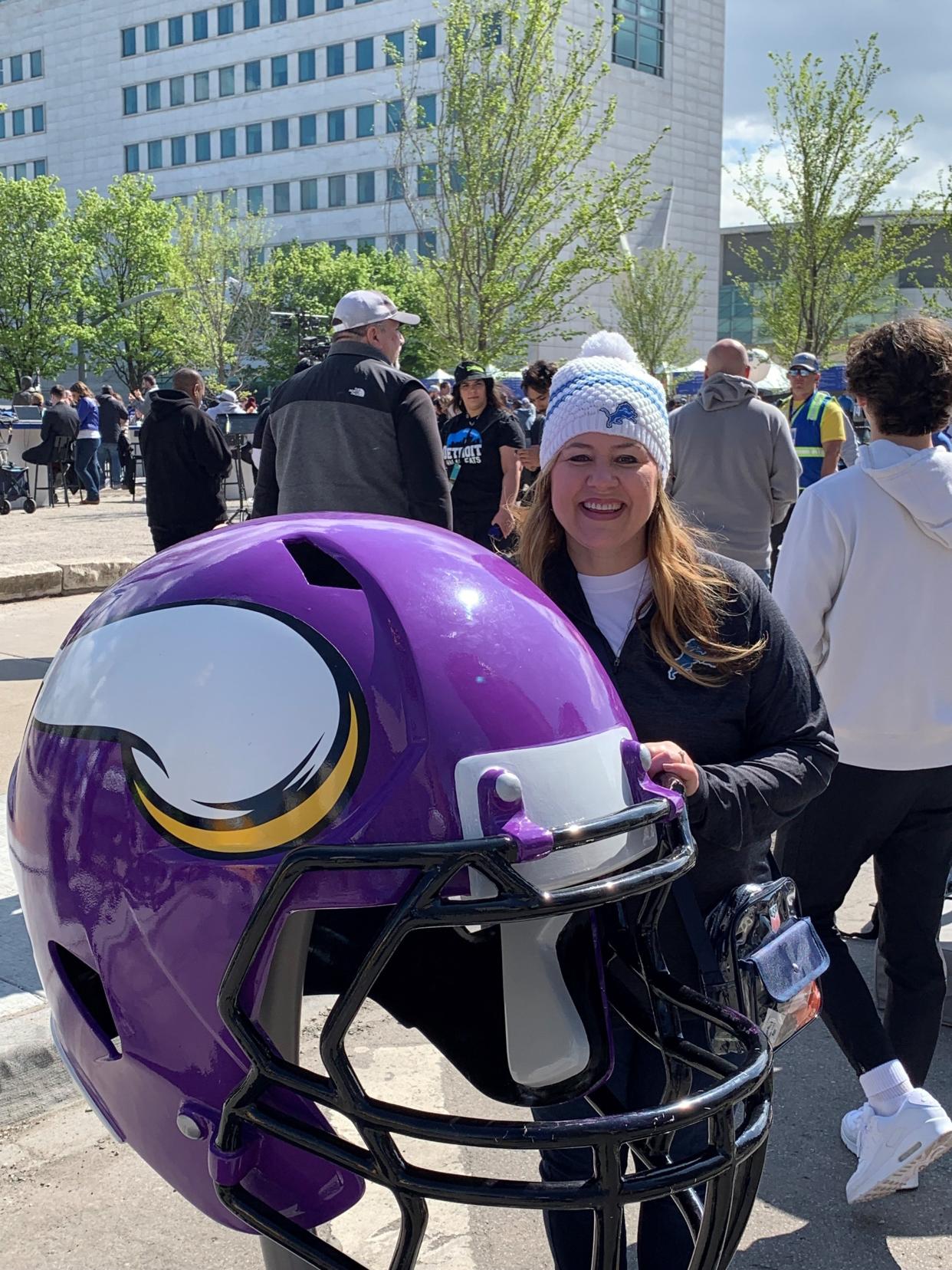 Detroit Free Press web editor Amy Huschka poses in front of a Minnesota Vikings helmet at Hart Plaza in downtown Detroit on Thursday, April 26, 2024 for the 2024 NFL draft. Her husband, former Free Press Editor Robert Huschka is a lifelong Minnesota Vikings fan. Amy is a Lions fan, much to her husband's eternal sadness.