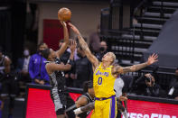 Sacramento Kings guard De'Aaron Fox (5) shoots over Los Angeles Lakers forward Kyle Kuzma (0) during the second quarter of an NBA basketball game in Sacramento, Calif., Friday, April 2, 2021. (AP Photo/Hector Amezcua)