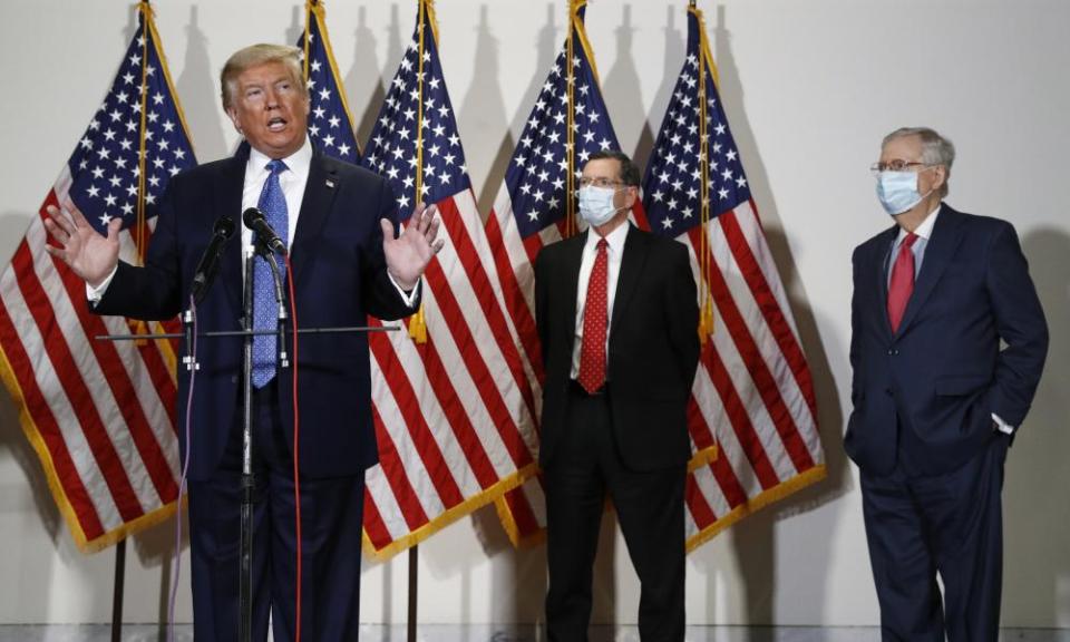 Donald Trump speaks. Senators John Barrasso and Mitch McConnell wear masks.