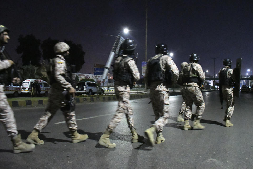 Paramilitary soldiers arrive at the incident site following gunmen attack on police headquarters, in Karachi, Pakistan, Friday, Feb. 17, 2023. Militants launched a brazen attack on the police headquarters of Pakistan's largest city on Friday, officials said, as the sound of gunfire and grenade explosions rocked the heart of Karachi. (AP Photo/Ikram Suri)