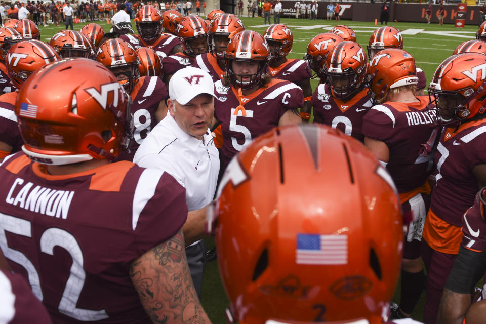 Justin Fuente of the Virginia Tech Hokies speaks to his team inside a huddle prior to the game against the Furman Paladins at Lane Stadium on September 14, 2019 in Blacksburg, Virginia. (Getty)