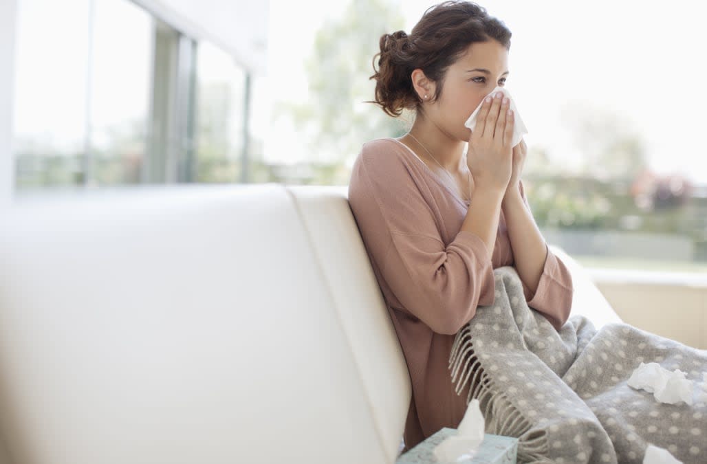 Sick woman blowing her nose