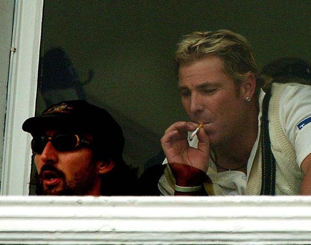 Shane Warne puffs on a cigarette in the dressing room during a rain delay against England during the first day of the fourth npower Test match at Trent Bridge