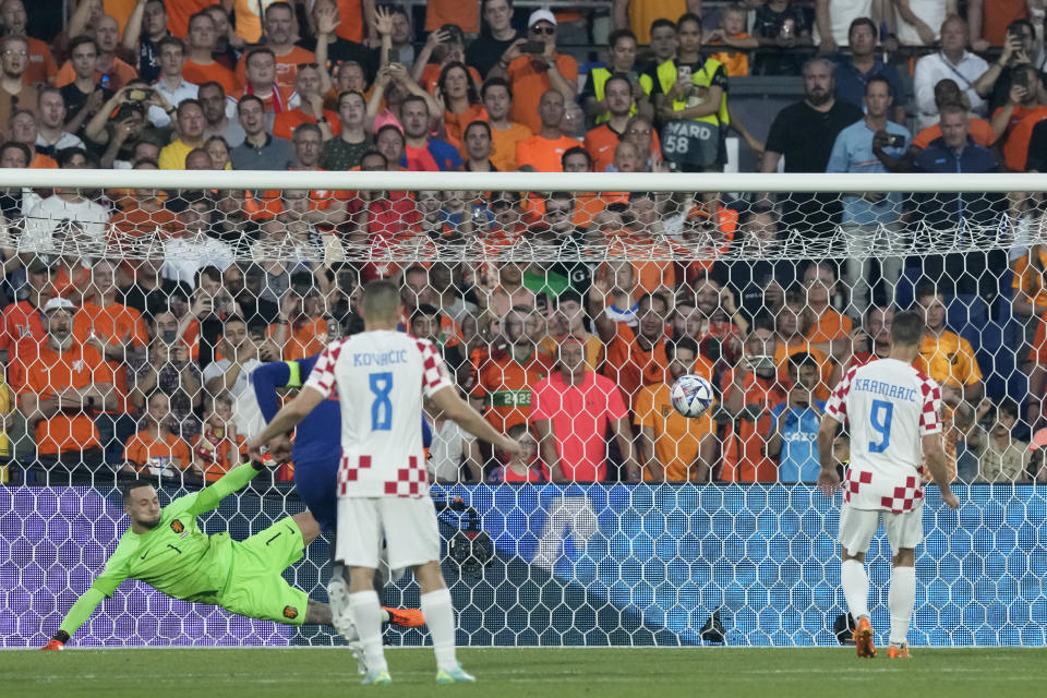 Croatia's Andrej Kramaric scores his side's first goal from the penalty spot past Netherlands goalkeeper Justin Bijlow during the Nations League semifinal soccer match between the Netherlands and Croatia at De Kuip stadium in Rotterdam, Netherlands, Wednesday, June 14, 2023. (AP Photo/Peter Dejong)