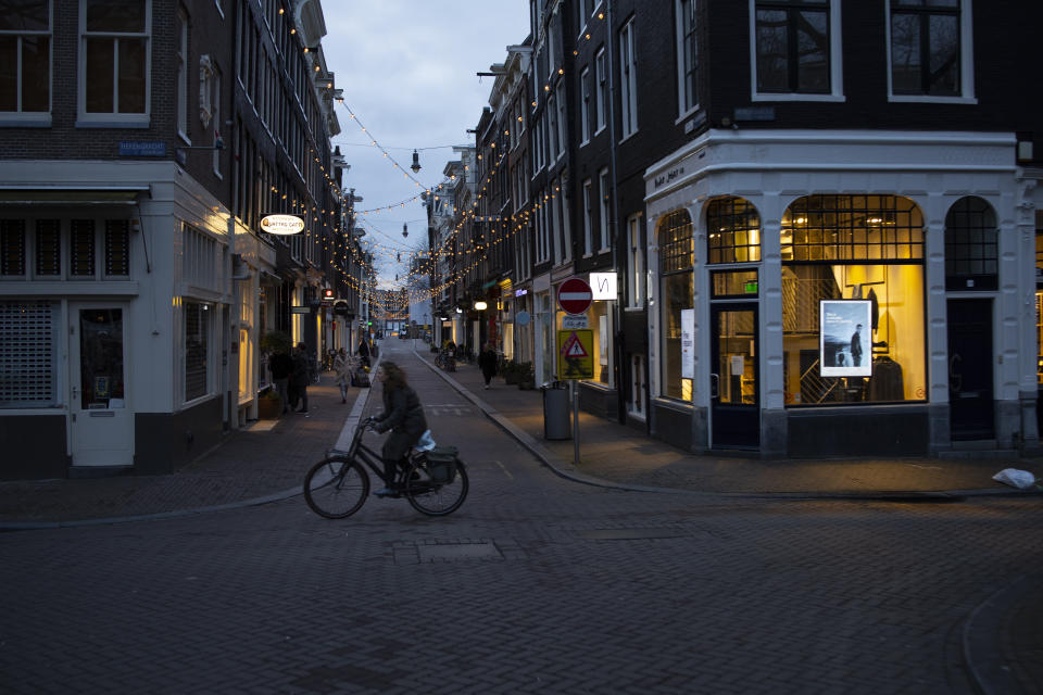 The capital's popular Nine Streets shopping area is near-deserted during lockdown in Amsterdam, Thursday, Jan. 14, 2021. The Dutch government this week extended by three weeks the tough lockdown in force since mid-December amid fears that coronavirus infection rates are not declining quickly enough and fears about a new more transmissible variant of the virus. (AP Photo/Peter Dejong)