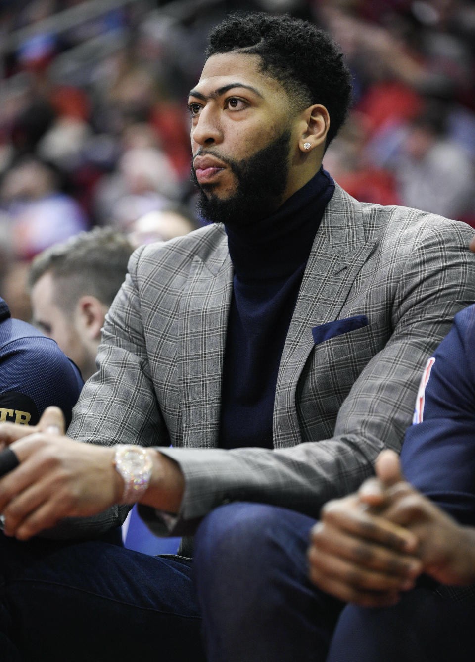 New Orleans Pelicans forward Anthony Davis watches from the bench during the first half of the team's NBA basketball game against the Houston Rockets, Tuesday, Jan. 29, 2019, in Houston. (AP Photo/Eric Christian Smith)