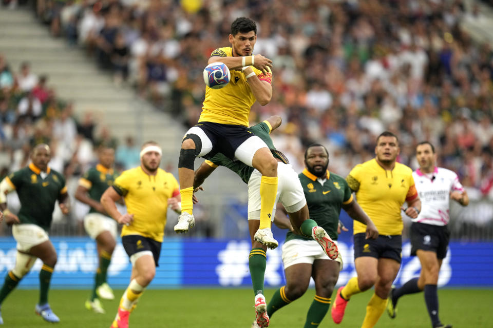 Romania's Marius Simionescu, top, jumps for the ball during the Rugby World Cup Pool B match between South Africa and Romania at the Stade de Bordeaux in Bordeaux, France, Sunday, Sept. 17, 2023. (AP Photo/Themba Hadebe)