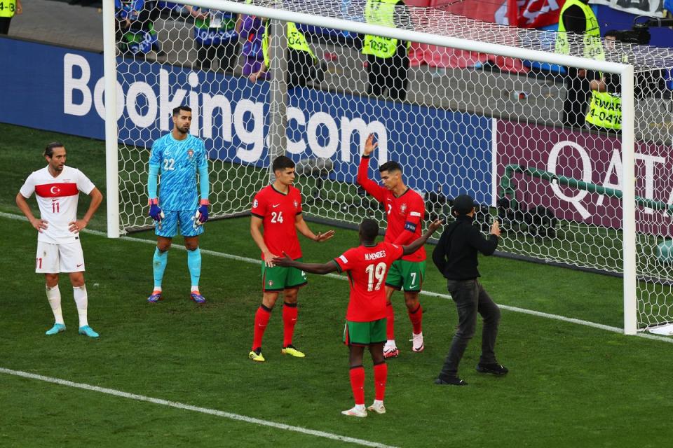 One fan reached Ronaldo at a corner as chaotic scenes marred the end of the game (Getty Images)