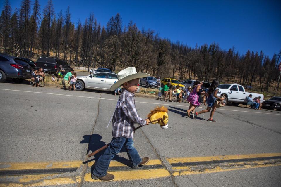 Trenton Savala, 4, marches with his wooden hobby horse at the Gold Diggers Day parade in Greenville.