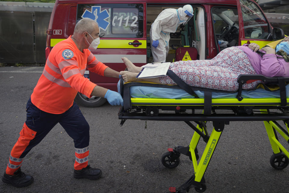 Paramedics push a stretcher as they bring a patient to the University Emergency Hospital in Bucharest, Romania, Friday, Oct. 22, 2021. In Romania, a European Union country of around 19 million, only 35% of adults are fully inoculated against COVID-19 compared to an EU average of 74%.(AP Photo/Vadim Ghirda)