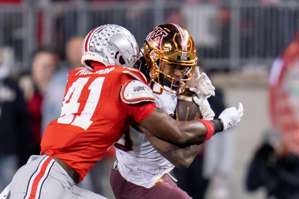 Nov 18, 2023; Columbus, Ohio, USA; 
Ohio State Buckeyes safety Josh Proctor (41) tackles Minnesota Golden Gophers running back Jordan Nubin (30) during the second half of their game on Saturday, Nov. 18, 2023 at Ohio Stadium.