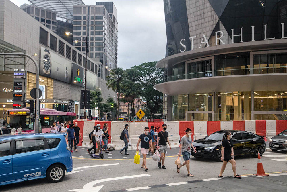 People are seen wearing protective masks as they walk along the Bukit Bintang shopping area in Kuala Lumpur on September 4, 2021. — Picture by Firdaus Latif