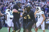 Purdue wide receiver David Bell (3) celebrates a touchdown with offensive lineman Spencer Holstege (75) during the first half of an NCAA college football game against Michigan State in West Lafayette, Ind., Saturday, Nov. 6, 2021. (AP Photo/Michael Conroy)