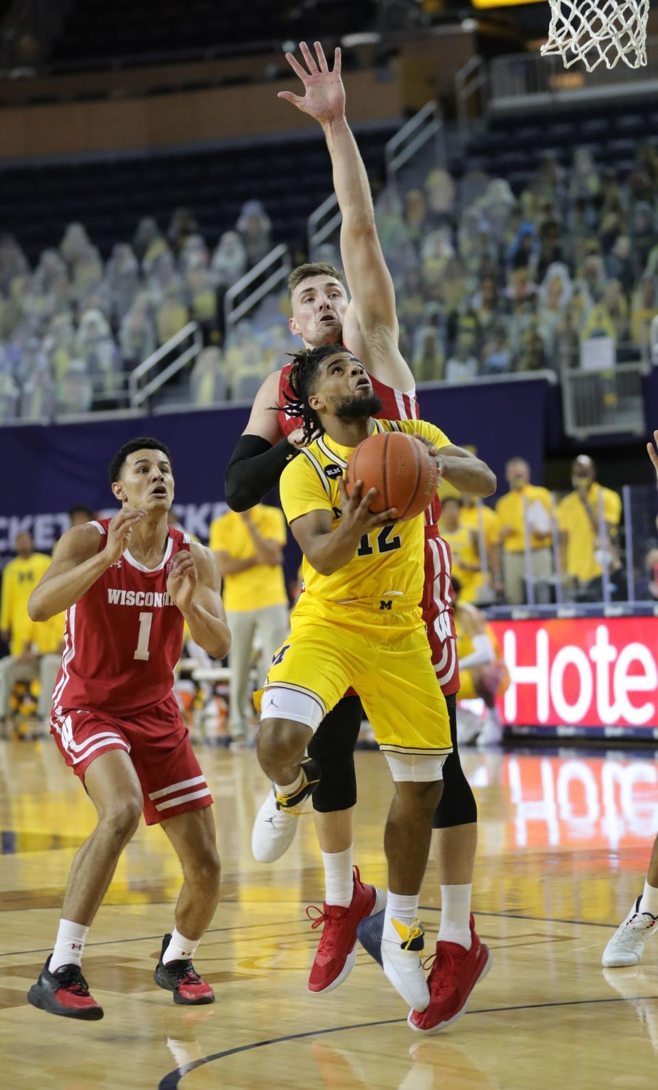 Michigan guard Mike Smith drives against Wisconsin forward Micah Potter during the first half at Crisler Center on Tuesday, Jan. 12, 2021.