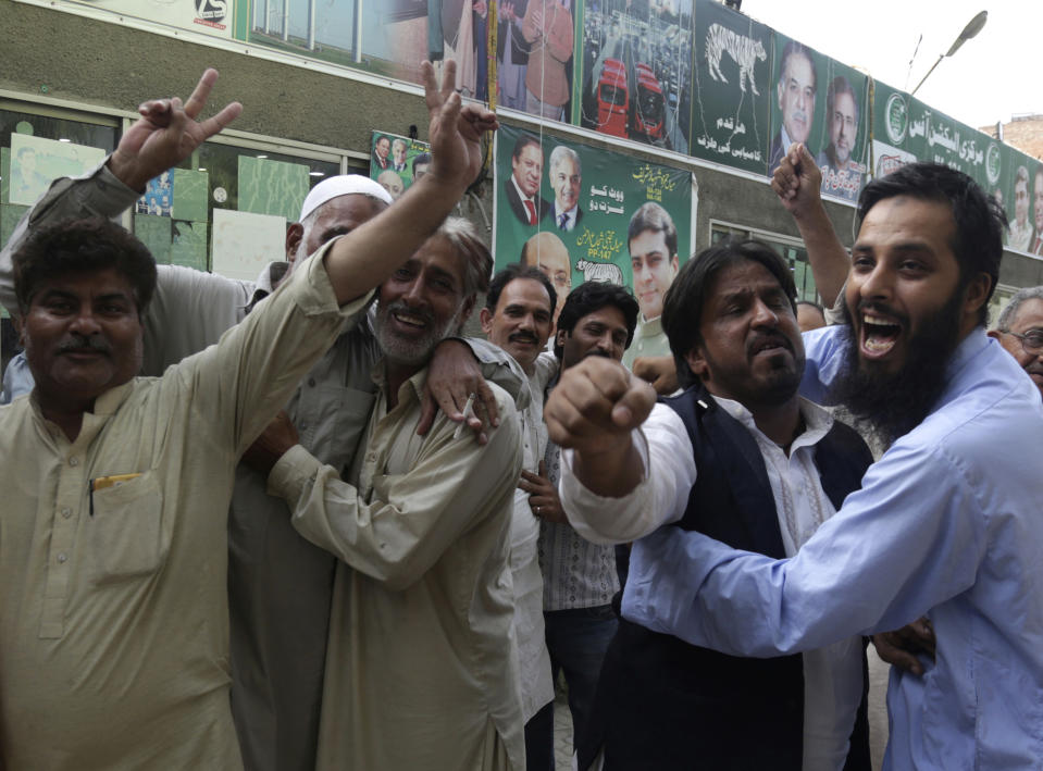 Supporters of Pakistani Prime Minister Nawaz Sharif celebrate the suspension of prison sentences of Sharif, his daughter and son-in-law, in Lahore, Pakistan, Wednesday, Sept. 19, 2018. The Islamabad High Court set them free on bail pending their appeal hearings. The court made the decision on the corruption case handed down to the Sharifs by an anti-graft tribunal earlier this year. (AP Photo/K.M. Chaudary)